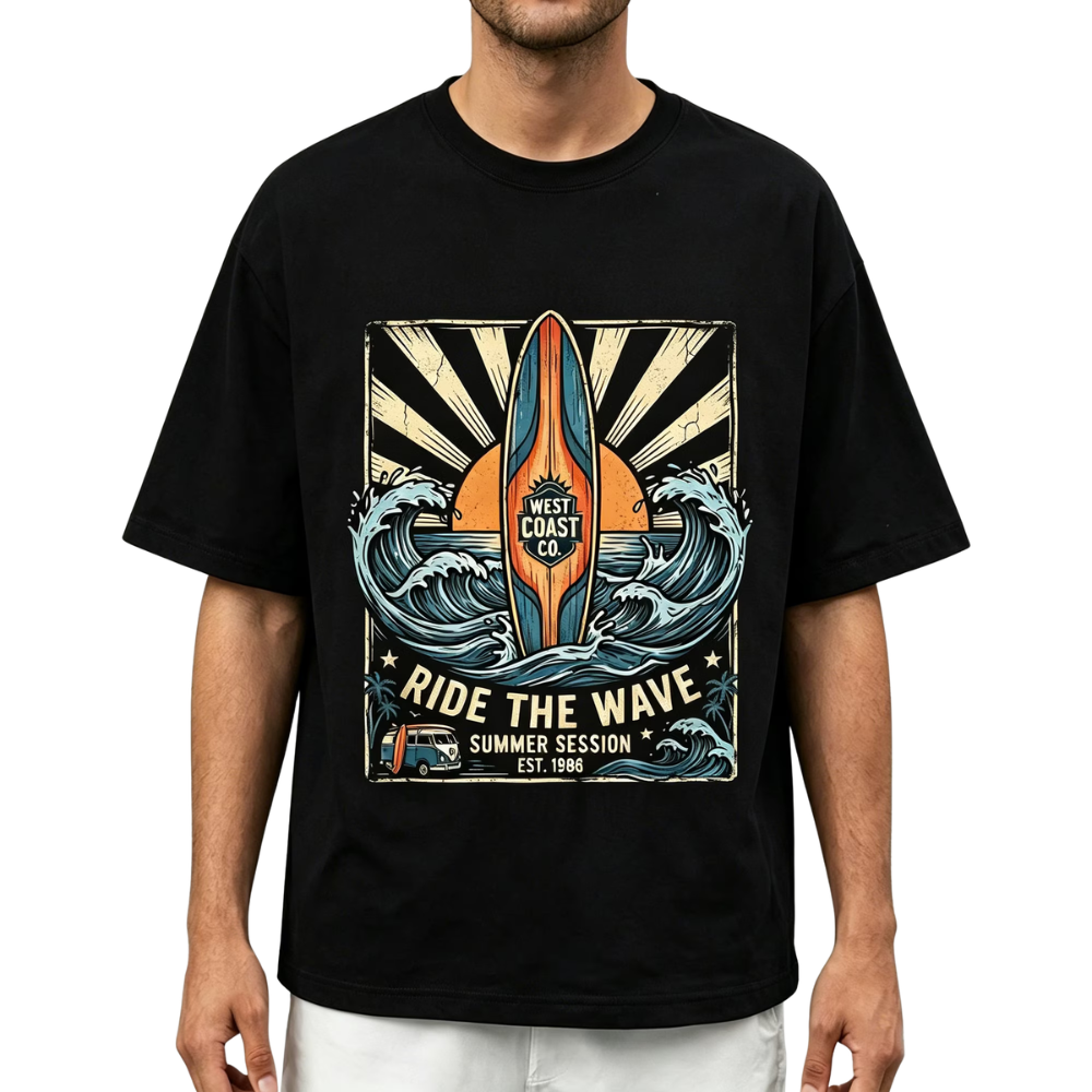 A man wearing a black short-sleeve t-shirt with a large vintage-style graphic on the chest featuring a surfboard, ocean waves, and the text 'WEST COAST CO' and 'RIDE THE WAVE'.