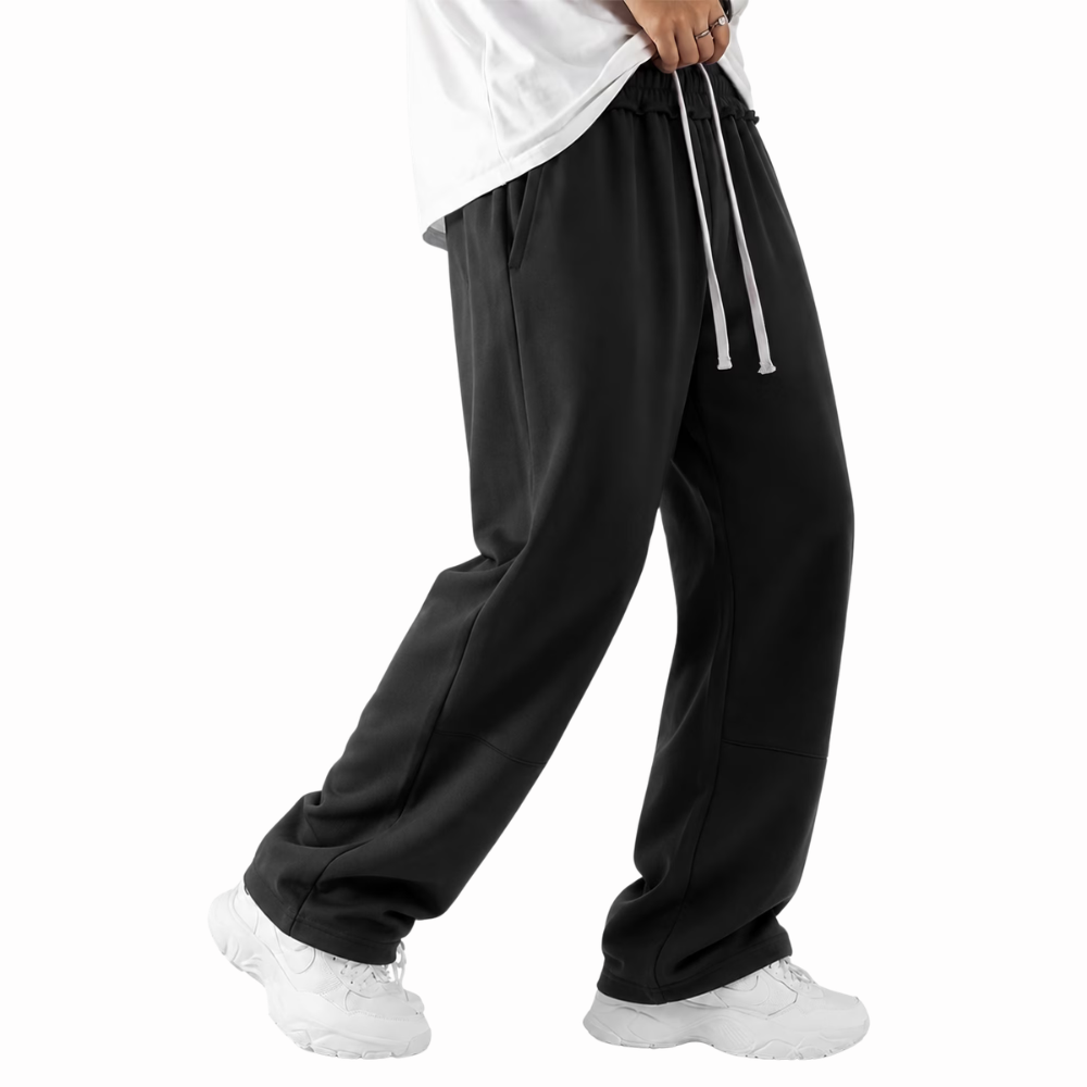 Side profile of men's baggy loose fit sweatpants with practical pockets and a relaxed athletic fit.