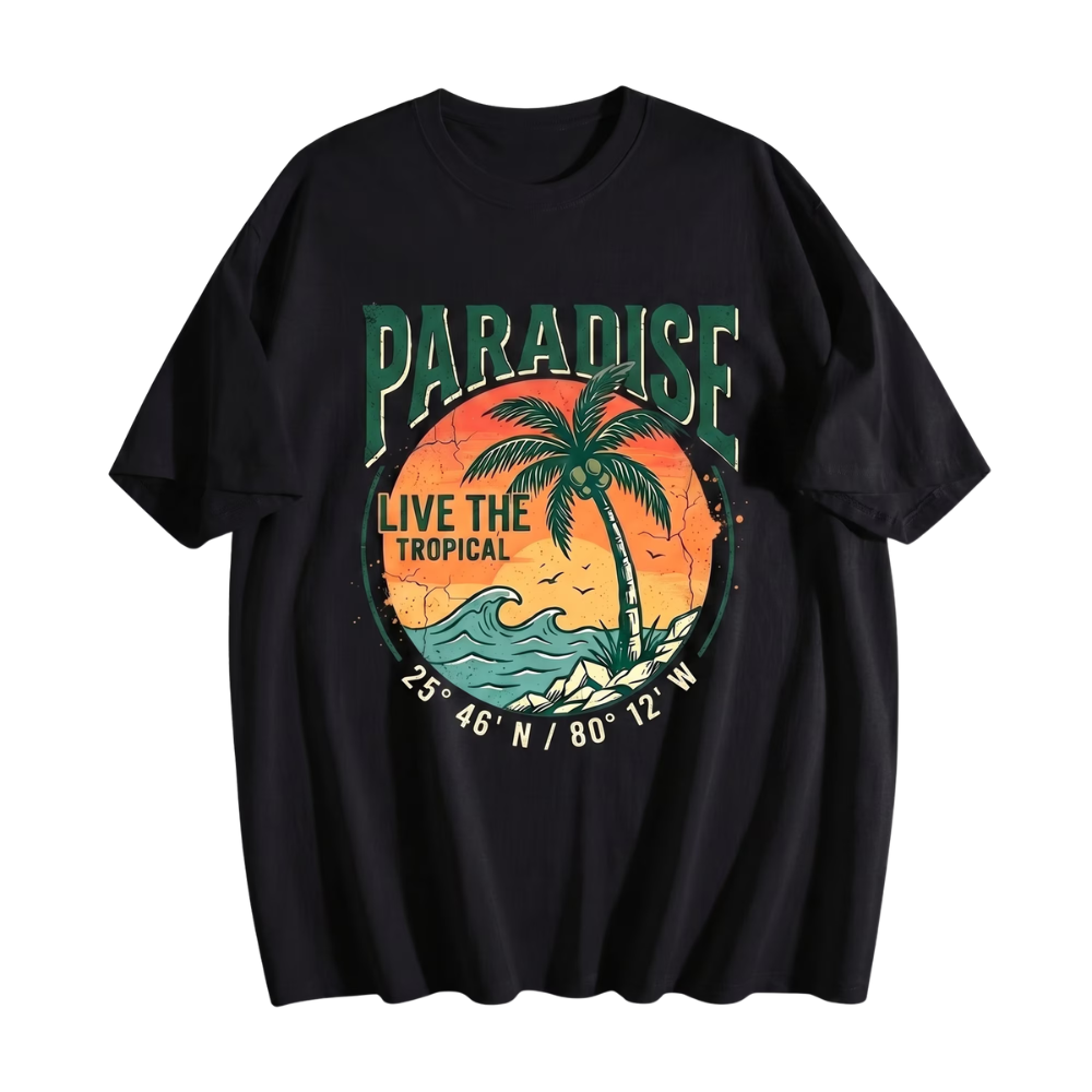 A black short-sleeve t-shirt with a retro-style tropical graphic on the front. The graphic features the word 'PARADISE' in green, a palm tree silhouetted against an orange sunset, the text 'LIVE THE TROPICAL', and coordinates '25° 46' N / 80° 12' W'.