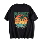 A black short-sleeve t-shirt with a retro-style tropical graphic on the front. The graphic features the word 'PARADISE' in green, a palm tree silhouetted against an orange sunset, the text 'LIVE THE TROPICAL', and coordinates '25° 46' N / 80° 12' W'.