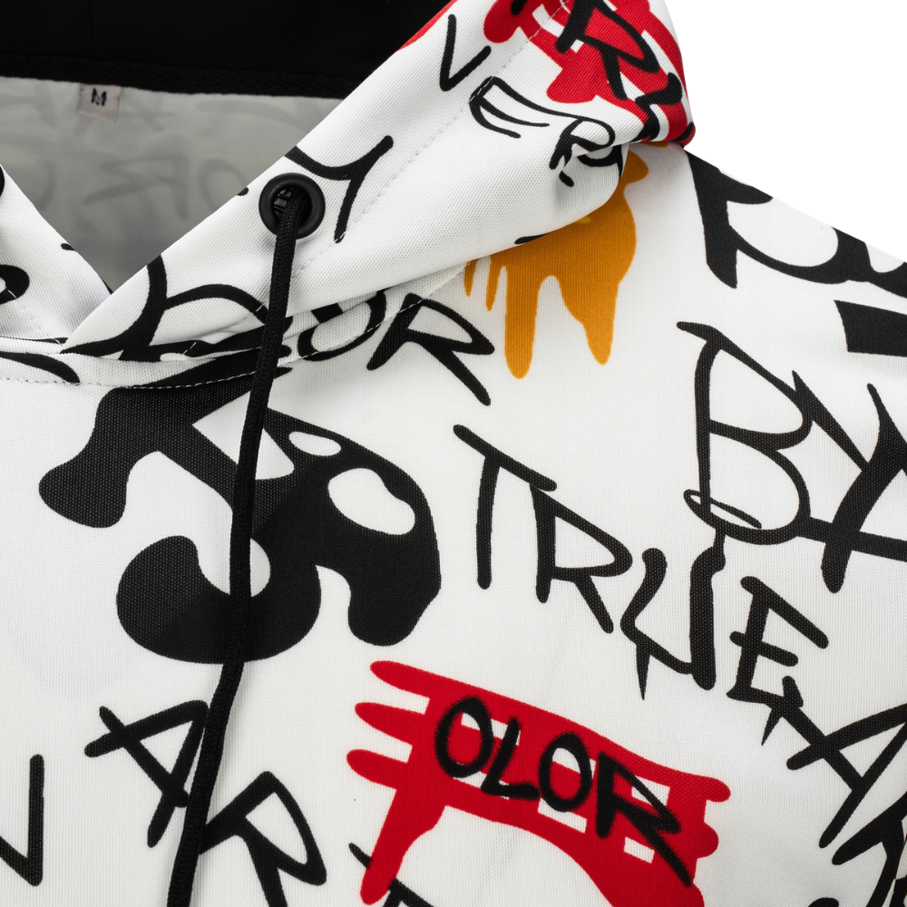 A close-up of a white hooded sweatshirt featuring a bold graffiti-style graphic print in black, red, and orange, with a black drawstring and a black snap closure.
