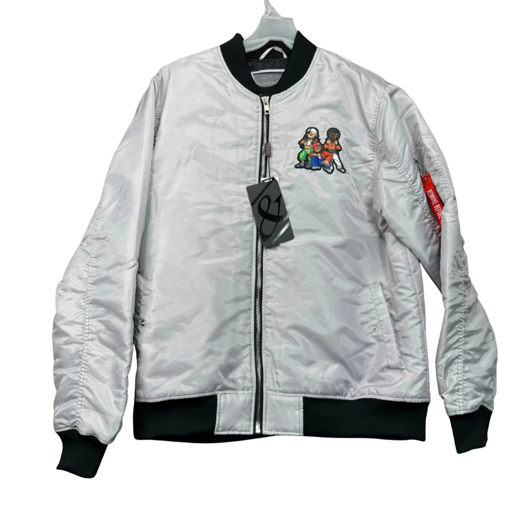 A silver nylon bomber jacket with black ribbed collar, cuffs, and hem, featuring a colorful cartoon graphic on the left chest and a red brand tag on the right sleeve.