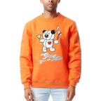 A man wearing an orange crewneck sweatshirt with a cartoon bear graphic and the text 'Buzz Barris' on the front, paired with light blue jeans against a white background.