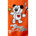 An orange graphic print featuring a white stitched teddy bear with a red heart on its chest, holding a silver axe, alongside a yellow diamond and the text 'Silencer Born with Sin' in stylized white and silver lettering.
